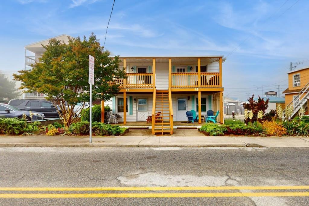 a yellow house with a deck on a street at Straney #3-Sea Renity in Ocean City
