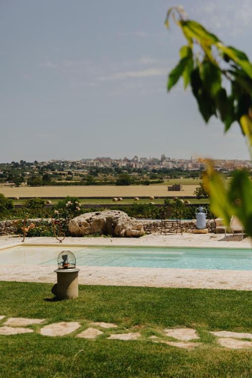 a view of a swimming pool in a park at Tenuta Colavecchio Wine Relais in Putignano