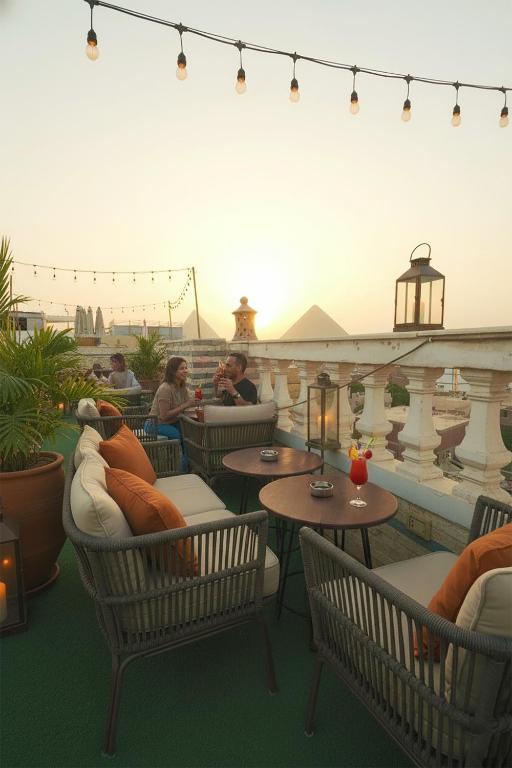 a rooftop patio with tables and chairs and people sitting at Pyramids Stars Egypt in Cairo