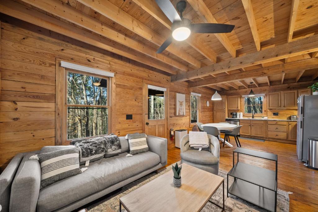 a living room with a couch and a table at Fox Trail Cabin in Boone