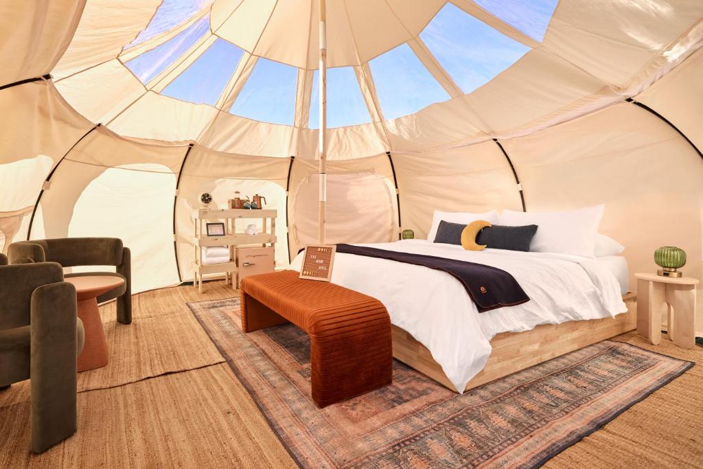 a bedroom with a bed in a tent at The Moon Hotel in Williams