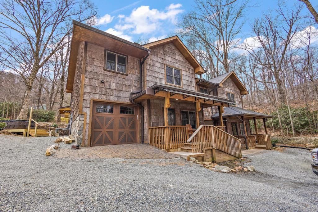 a wooden house with a garage and a driveway at License to Chill Boone in Banner Elk