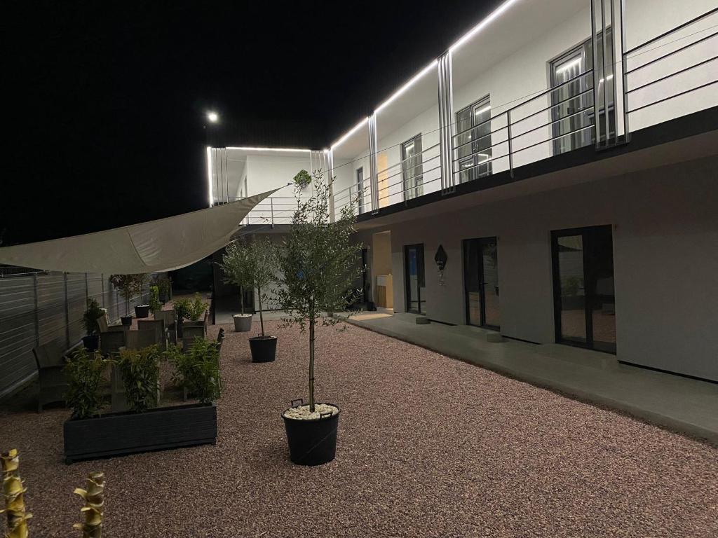a courtyard of a building with potted plants and lights at Rifugio Blu in Costinesti