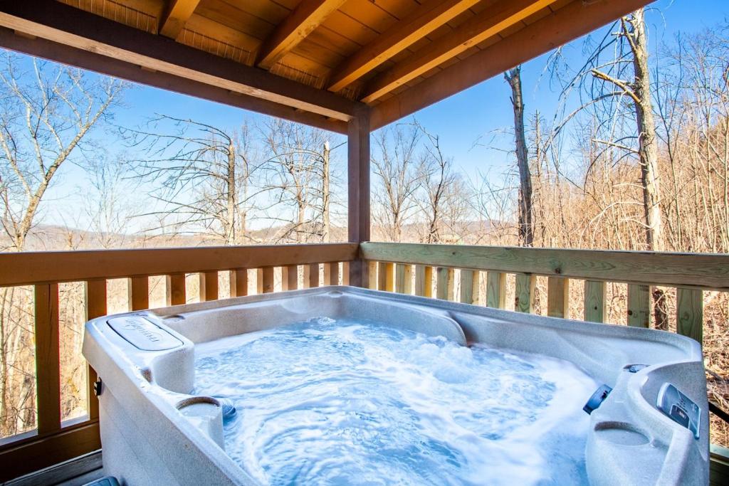 a hot tub on the deck of a house at Whisk-A-Way - Hot Tub, Pool Table & Jacuzzi! in Abbeyville