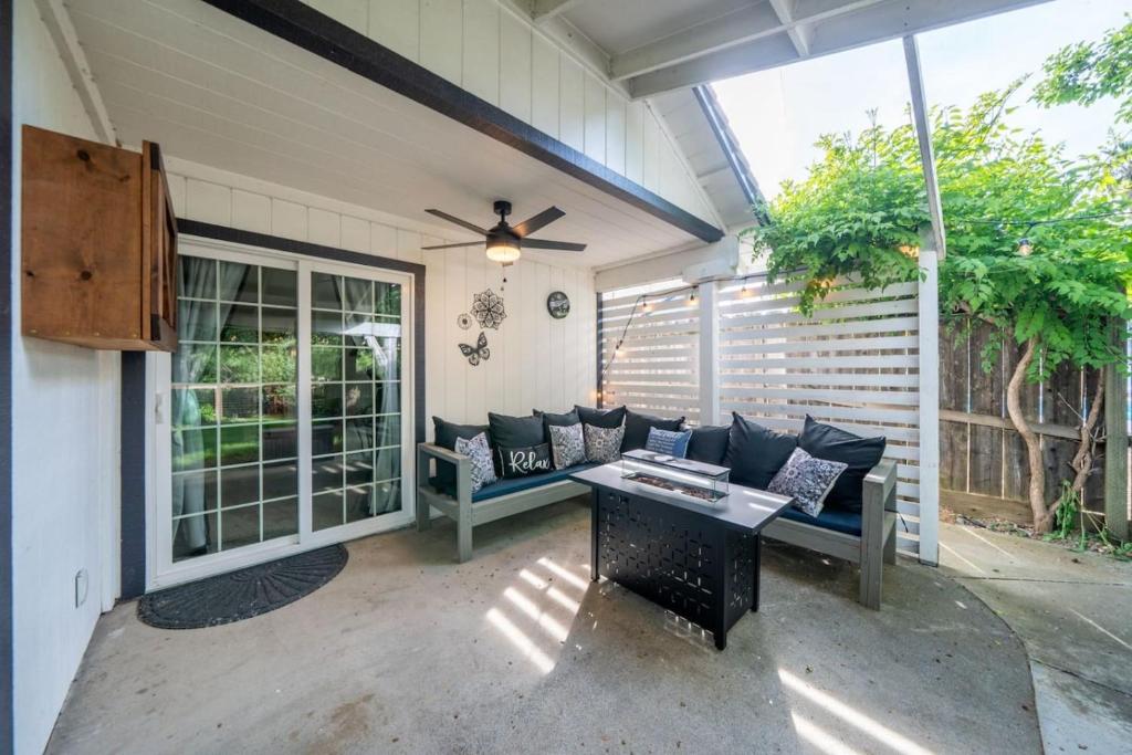 a screened in porch with a couch and a table at Martinique in Redding