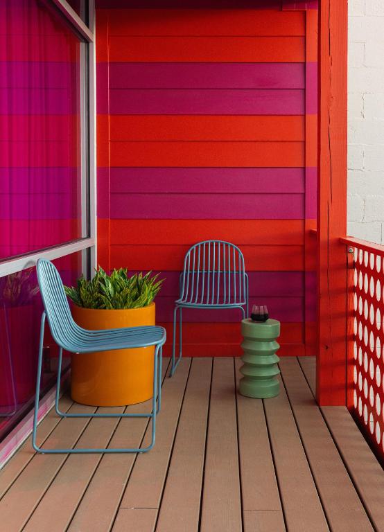 two chairs and a table on a colorful house at Hotel Hilo - Room 201 in Louisville