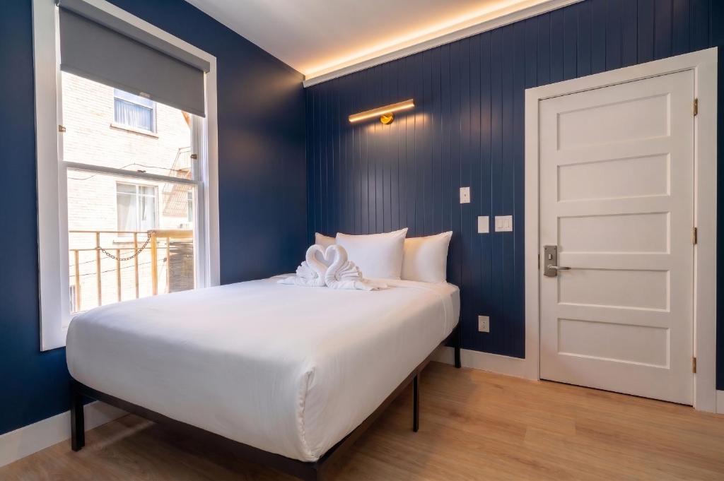 a bedroom with a white bed and a window at San Remo Hotel in San Francisco