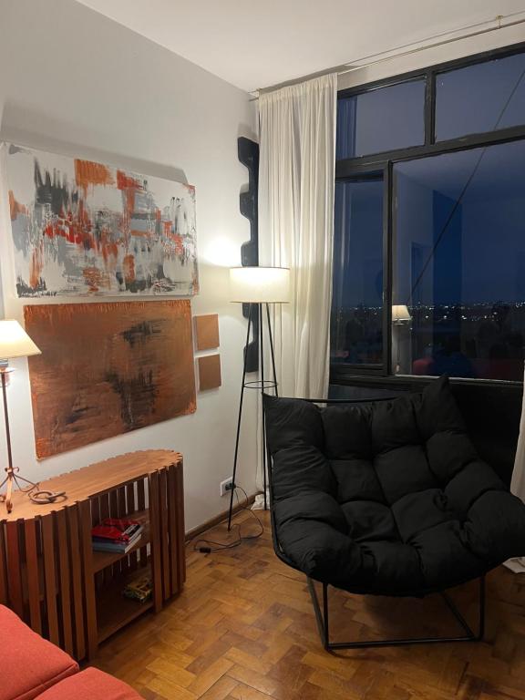 a living room with a couch and a large window at Departamento chic centro 2 habitaciones in Mendoza