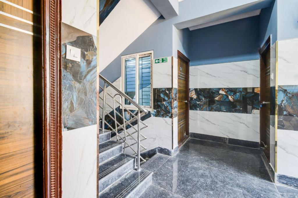 a staircase in a house with blue walls at Super Townhouse Hitech City Near Yashoda Hospital in Hyderabad
