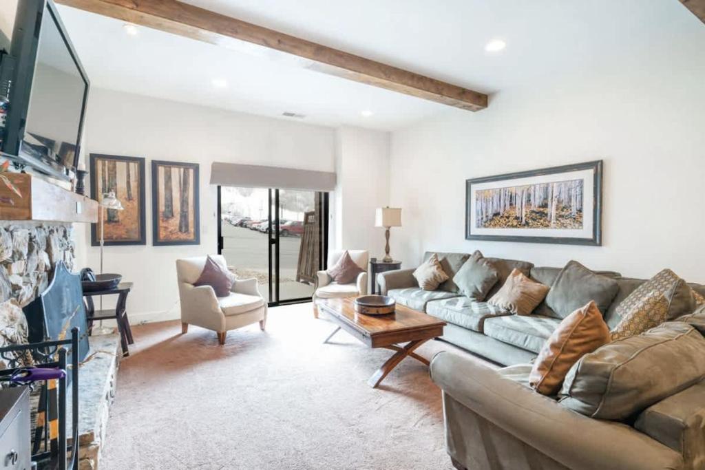 a living room with a couch and a table at Classic Ski-in Ski-out Condo in Park City