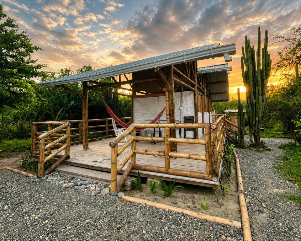 a small house with a roof and a fence at Bosque Seco Bioreserva & Hostel in Villavieja