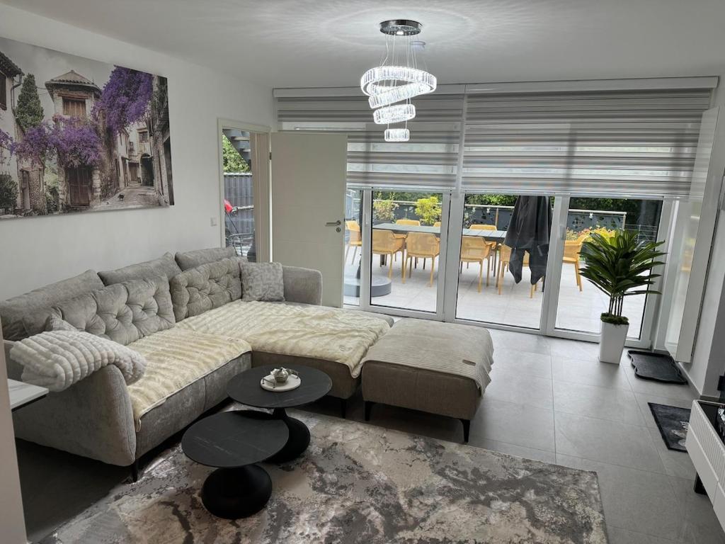 a living room with a couch and a table at Modernes Appartment in Schifflange in Schifflange