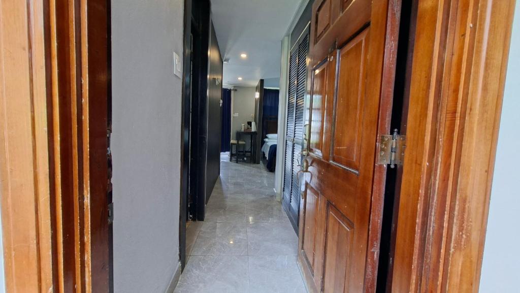 a hallway leading to a room with a door at Studio Suite 11 in Ocho Rios