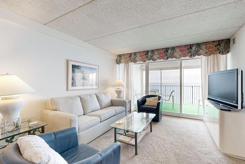a living room with a couch and a tv at English Towers 804 in Ocean City