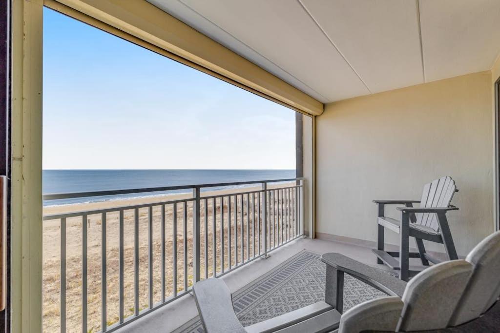 a balcony with chairs and a view of the beach at Salty Sands in Ocean City