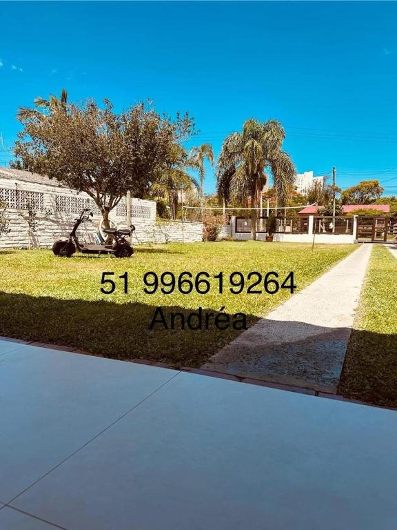 a sign that reads amore in a park at Canto dos pássaros in Tramandaí