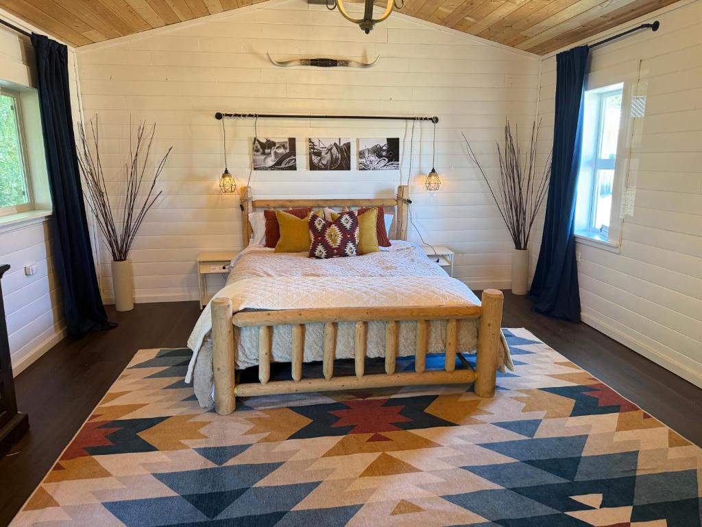 a bedroom with a bed and a rug at Willow Pond Cabin in Ellensburg