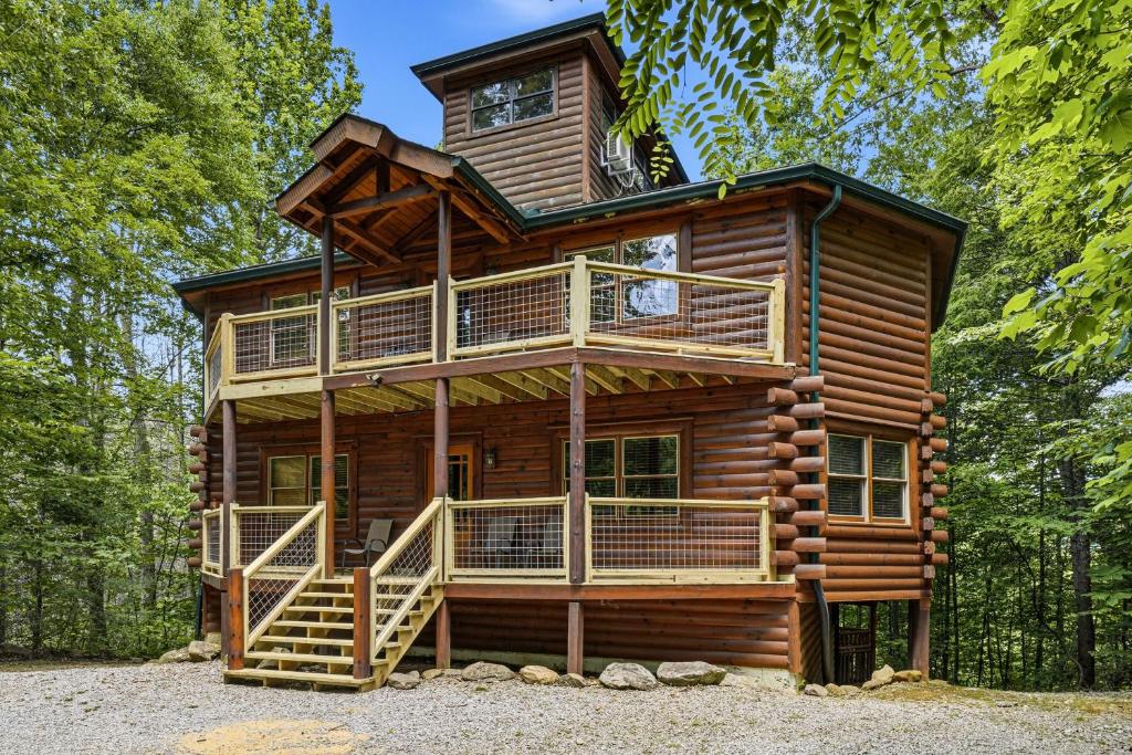 a log cabin with a tower on top of it at Cherokee Pool Lodge in Cosby