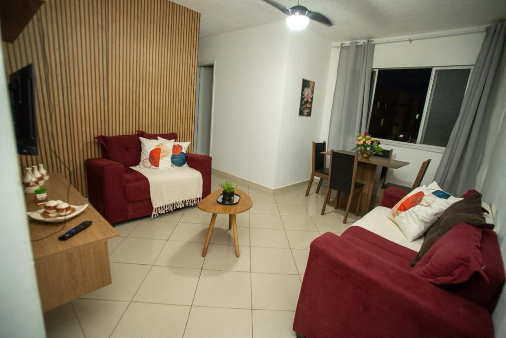 a living room with a couch and a table at Apartamento Morada dos Sonhos in Lauro de Freitas