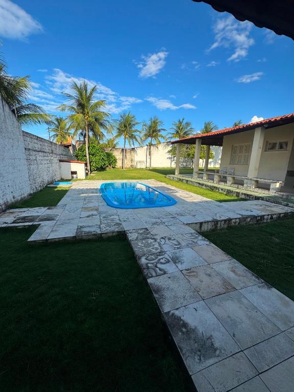 a swimming pool in the yard of a house at Casa de Praia do Morro Branco in Beberibe
