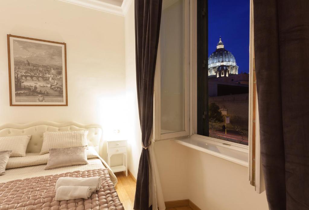 a bedroom with a large window with a view of a building at InnsideRome in Rome