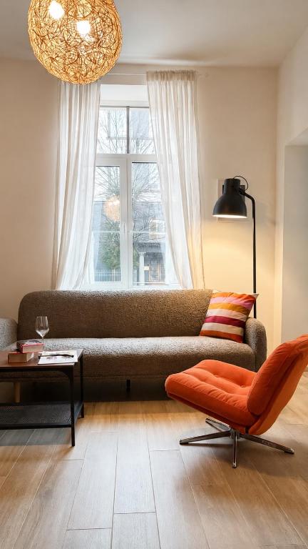 a living room with a couch and a window at Bright Cozy Apartment in Riga Quiet Center in Riga