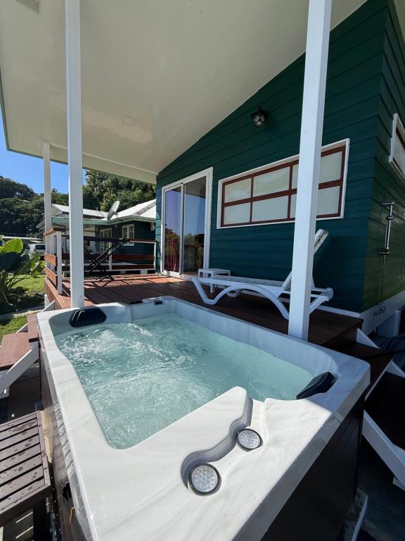 a swimming pool with a pair of scissors in it at Tuava - Mirimiri Lodge in Ataiti