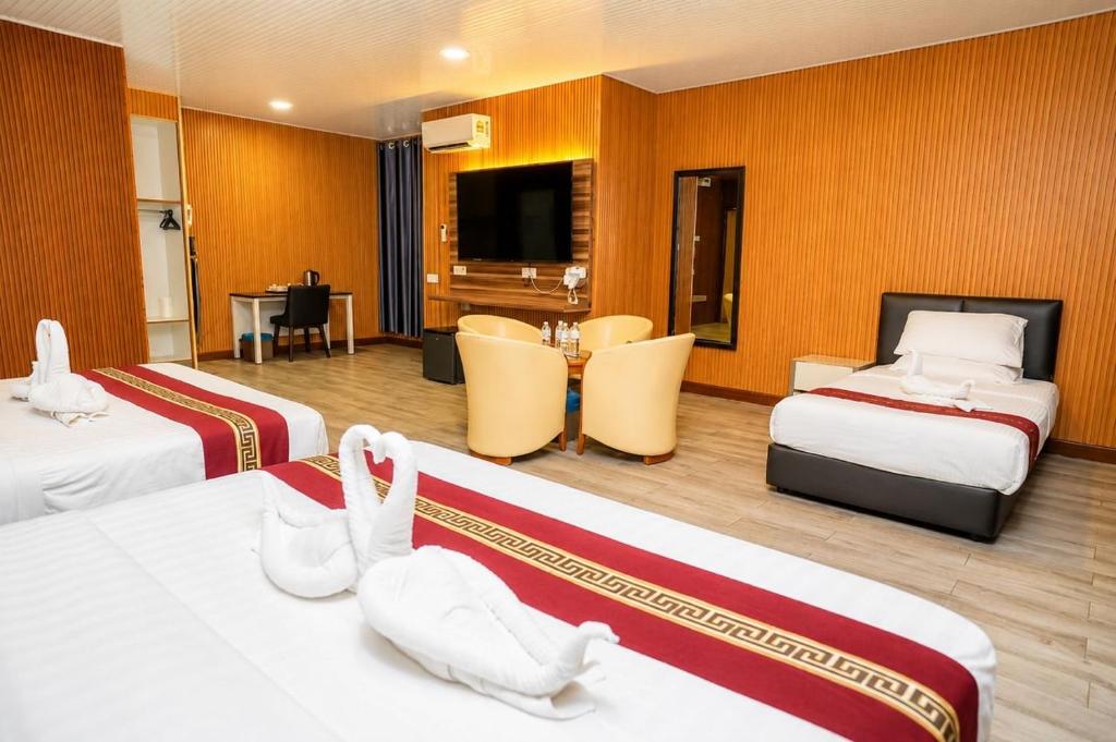 a hotel room with two beds and a television at SS Hotel Seremban in Seremban