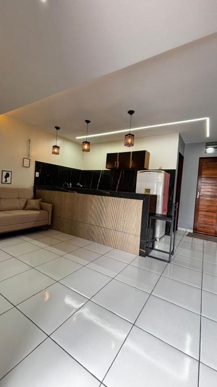 a living room with a couch and a table at Flat Ubuntu in Viçosa do Ceará