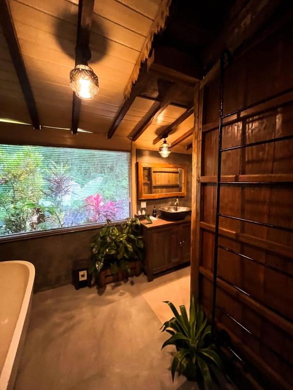 a bathroom with a large window and a sink at Sekumpul Bali Hidden Space in Singaraja
