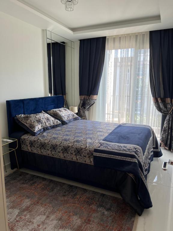 a bedroom with a bed and a large window at Best Home 38 Triumph in Alanya