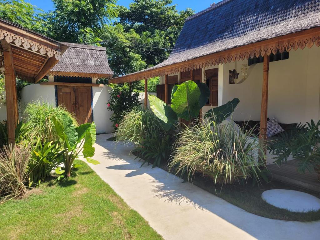 a house with a garden in front of it at Irmy's Village in Gili Islands