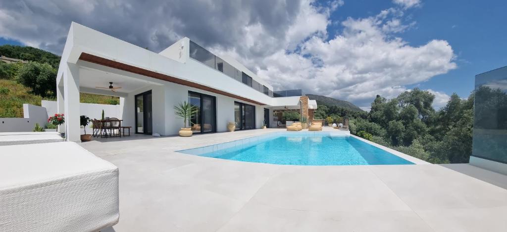 a villa with a swimming pool and a house at Villa Westwood in Parga