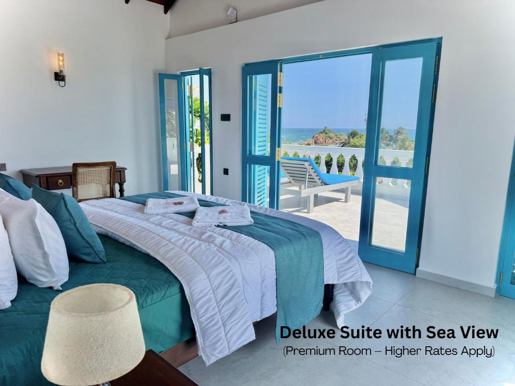 a bedroom with a bed with a view of the ocean at Seashore Mirissa in Mirissa