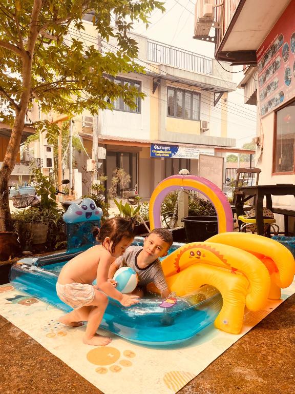 a boy and a girl playing in a water slide at Vangvieng dream house in Vang Vieng