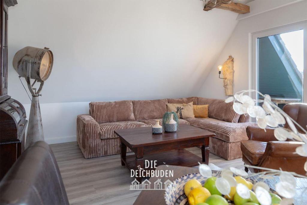 a living room with a couch and a table at Box-10 in Büsum