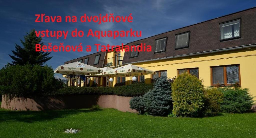 a sign on the side of a building at Penzion Agrothermal in Bešeňová