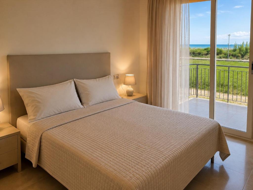 a bedroom with a bed and a large window at Oasi Frontemare Appartamenti in Pineto