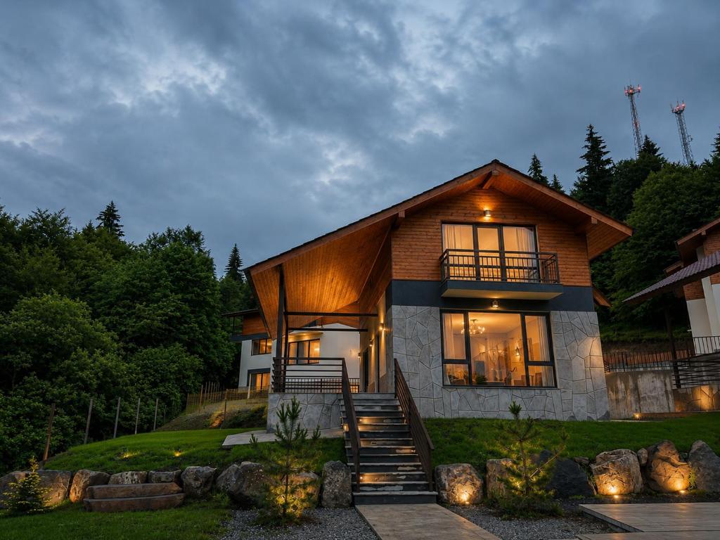 a house with lights on the front of it at Crown Villa Bakuriani in Bakuriani