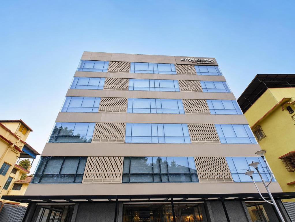 a tall building with a lot of windows at Hotel Aston Residency in Kolkata