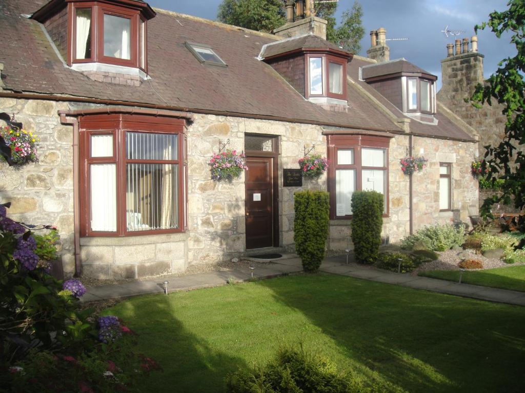 a house with a lawn in front of it at Beeches Guest House in Dyce