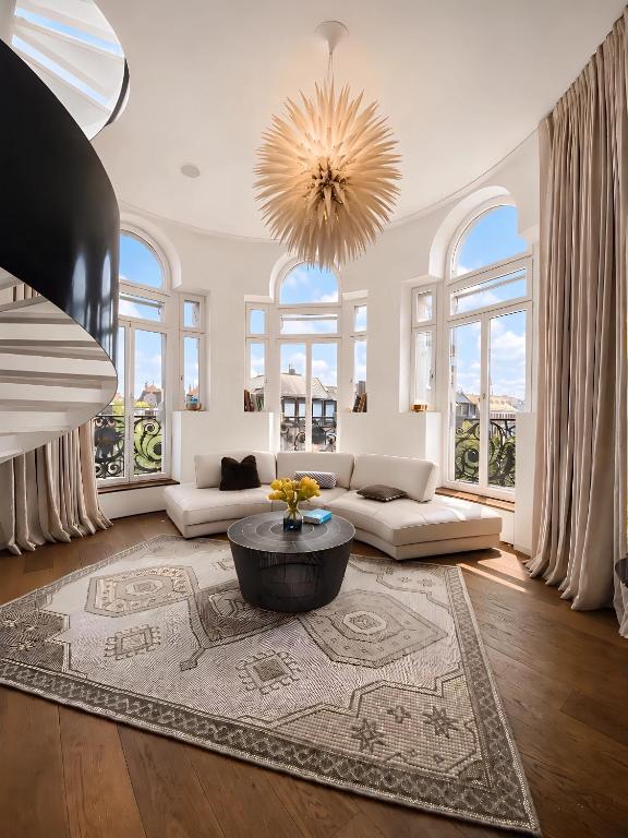 a large living room with a chandelier and a table at The Crown Penthouse Bahnhofstrasse in Zurich
