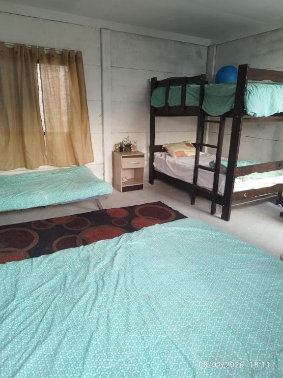 a room with two bunk beds and a bed at Tampu Machi Eco Camping in Chancayllo