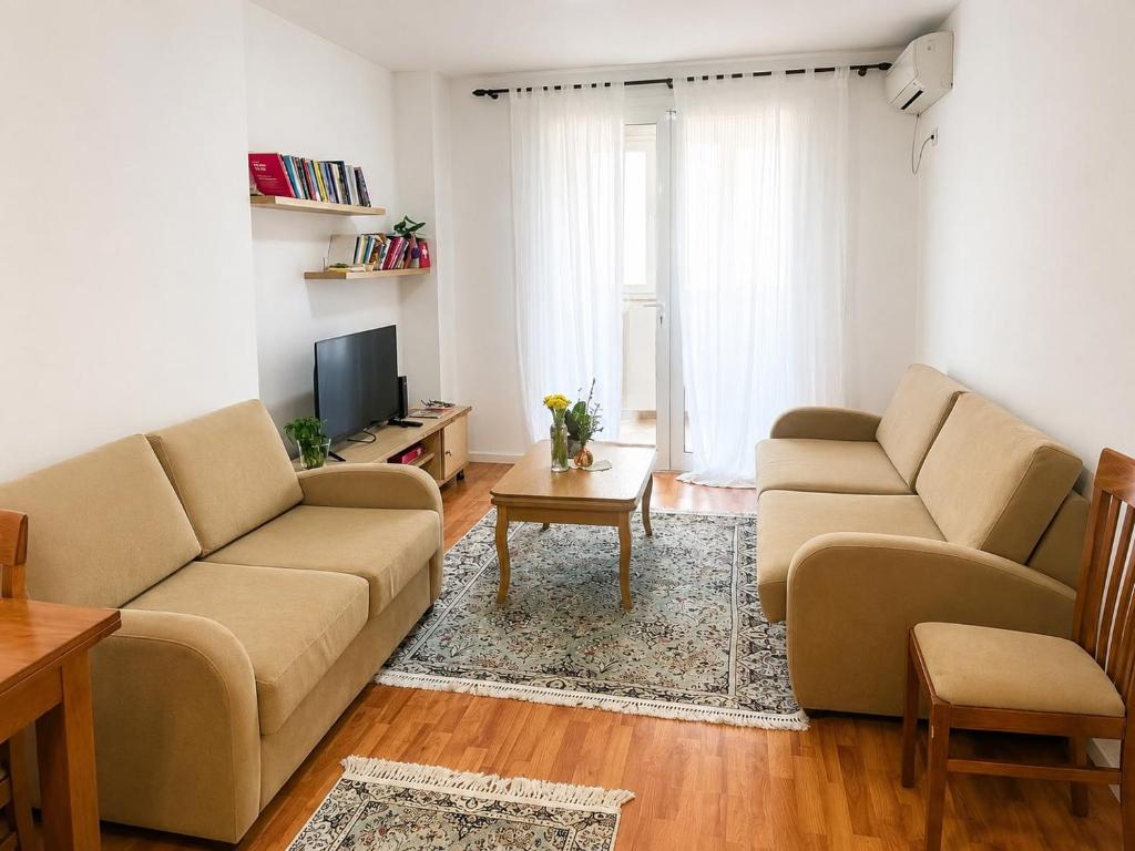 a living room with two couches and a tv at Cozy Apartment, Free Parking near Dajti Cable Car, Bunk'Art in Tirana