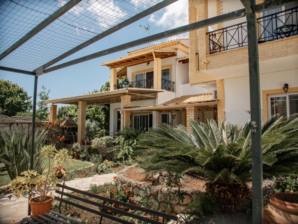 a house with a garden in front of it at Iron House in Agios Georgios