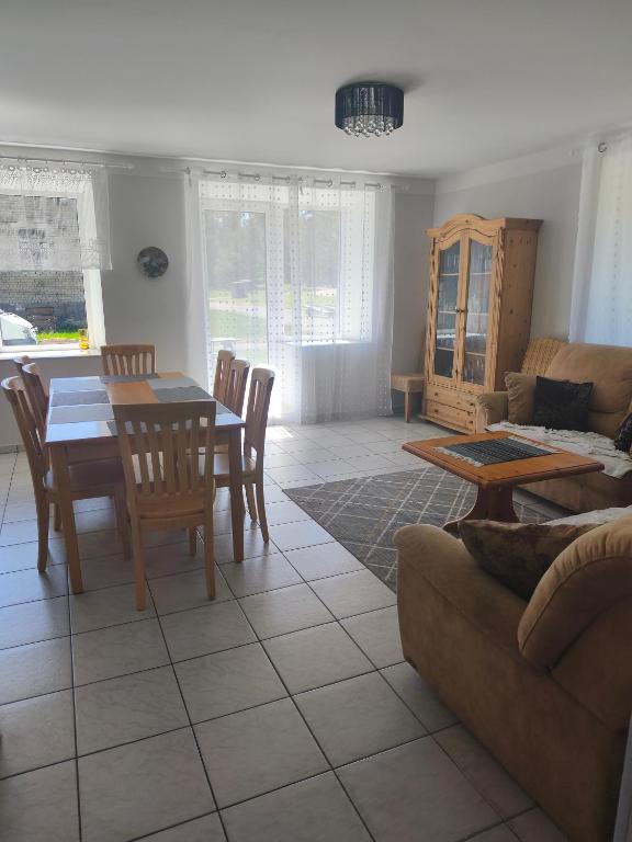 a living room with a table and a couch at Vormsi Ohvitseride Maja korter nr 3 in Hullo