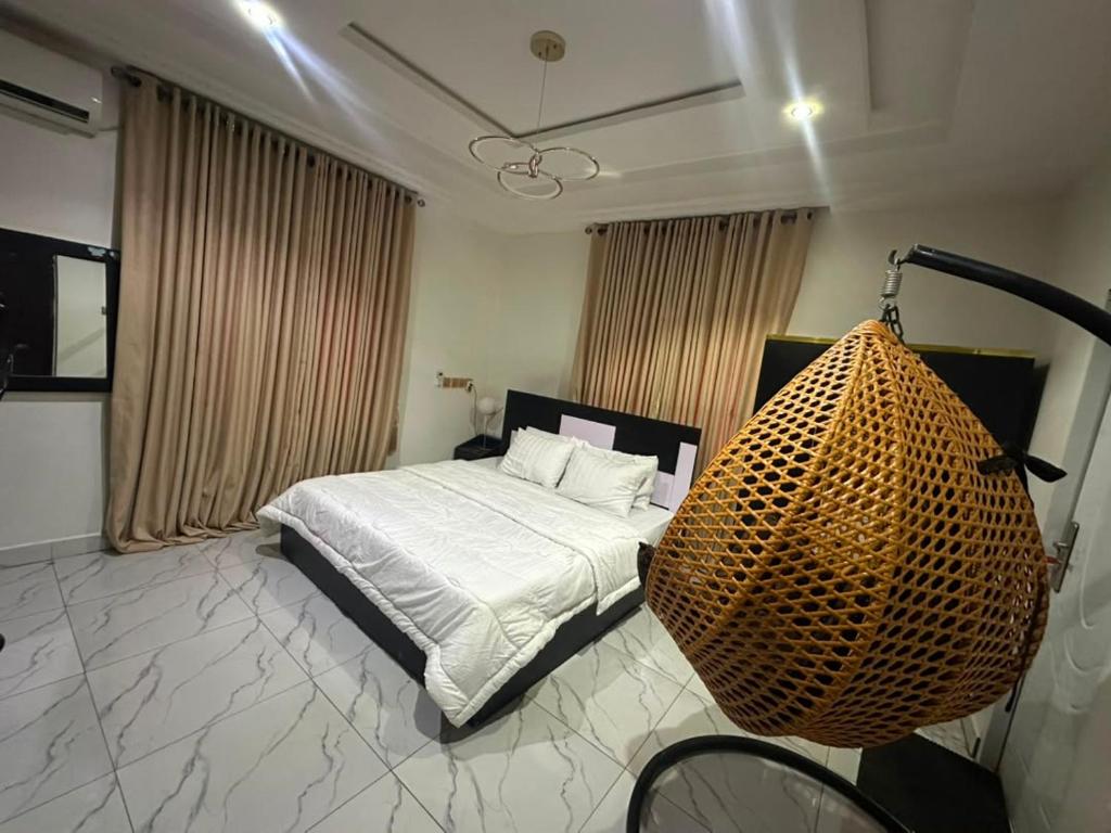 a bedroom with a bed and a bicycle in it at Cozy 2 Bedroom Apartment - Lugbe in Rubuchi