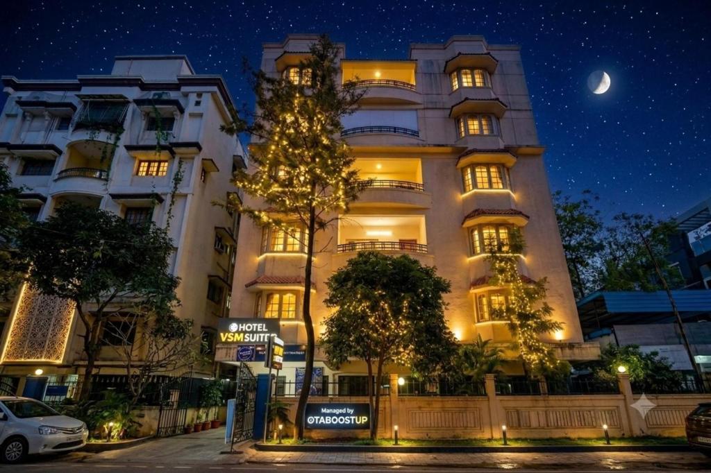 a building with a christmas tree in front of it at Hotel Velvet Stay Near DLF Cyber City in Hyderabad