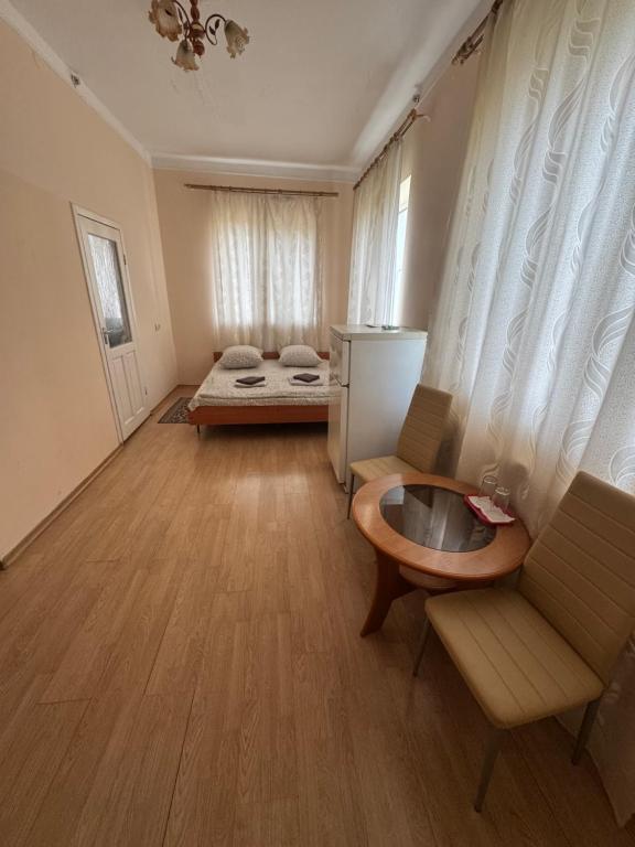 a bedroom with a bed and a table and a chair at Apollon in Mukacheve