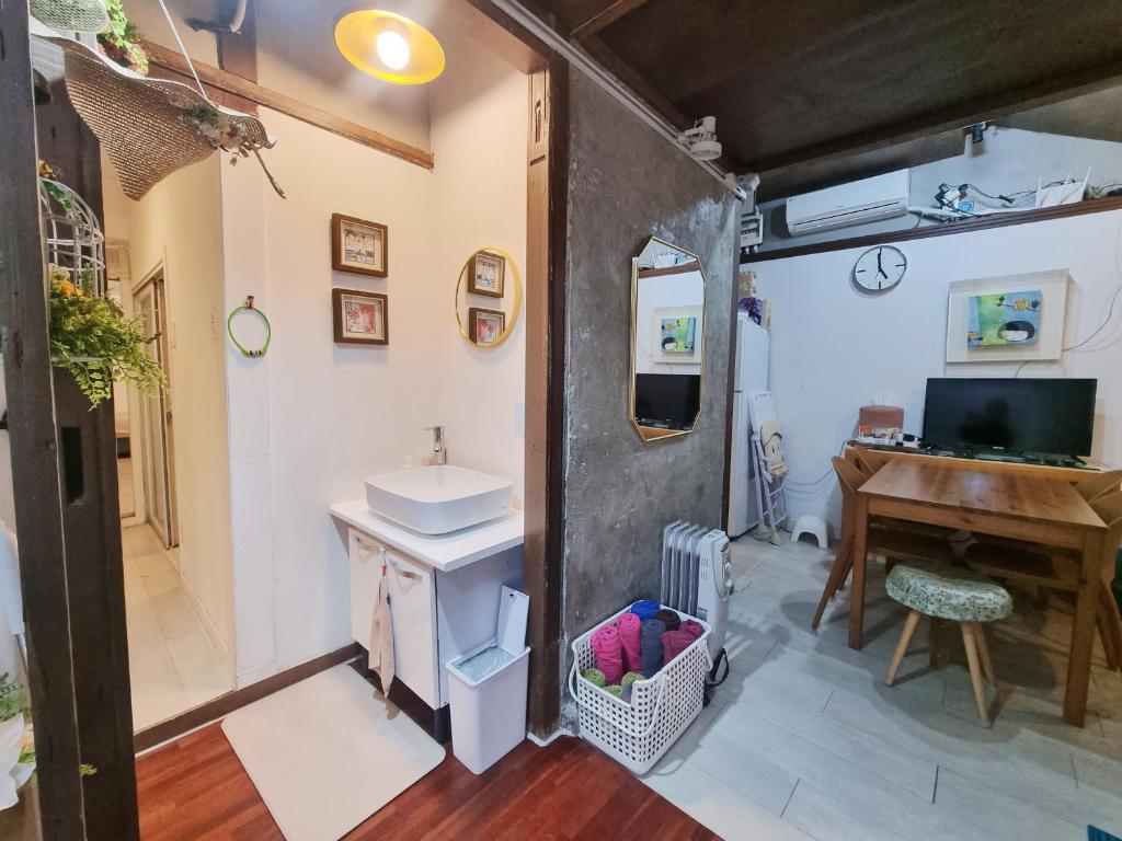 a bathroom with a sink and a desk and a piano at Ernie MyeongDon'g Sation 1Min, Anytime Check In in Seoul